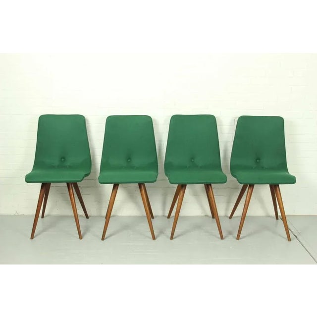 Set of four teak dining chairs by gj van os and made at furniture factory g.j. Van os n.v. In culemborg (netherlands) in...