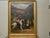 An English oil on canvas hunt painting from the 20th century depicting three dogs and their catch, in carved giltwood...