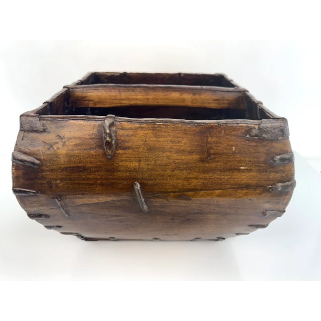 A richly patinated antique Chinese rice measure, hand-carved from solid wood and bound with original forged iron...