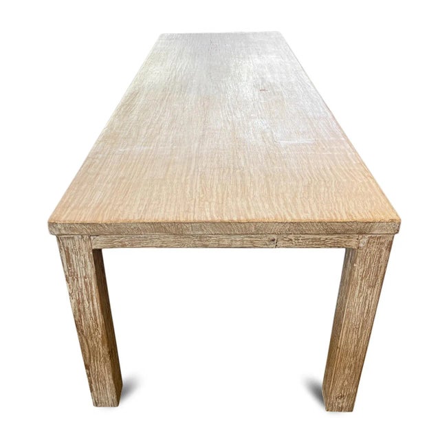 Substantial vintage elm dining table which offers a beautifully restrained and organic presence with its elongated...