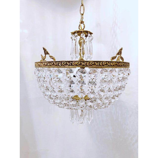 Italian Basket chandelier with decorative brass rim and 30% led graduated octagon chain and U-drop crystals. It has 3...