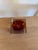 A small sommerso catchall in faceted Murano glass — an amber and orange core suspended inside a thick clear casing....