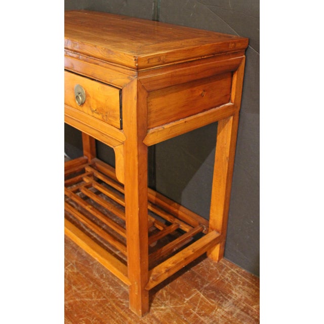 Qing Dynasty console table, Chinese. Made of Ym Mu (elm). Floating panel top, over two drawers with metal (possibly...