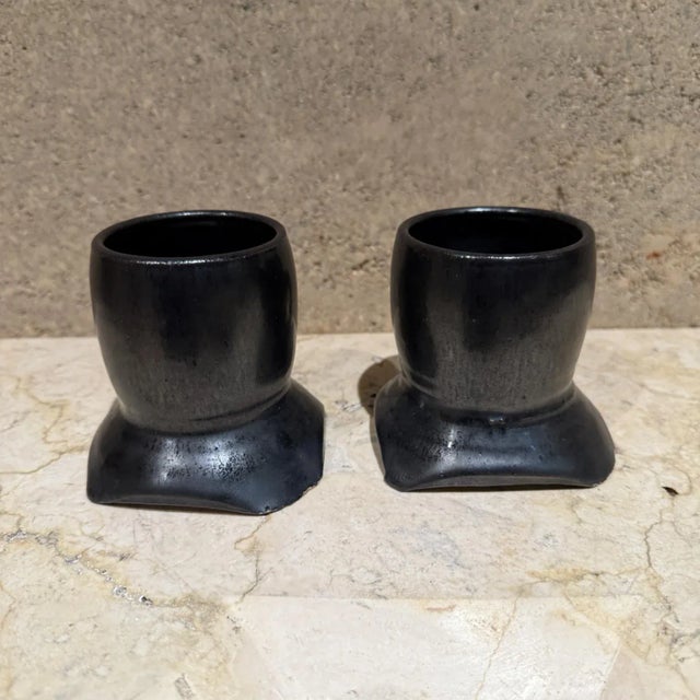 For your consideration, a pair coffee mugs. Sculptural pottery earthenware art. Signed by artist 1983 Melching Black...