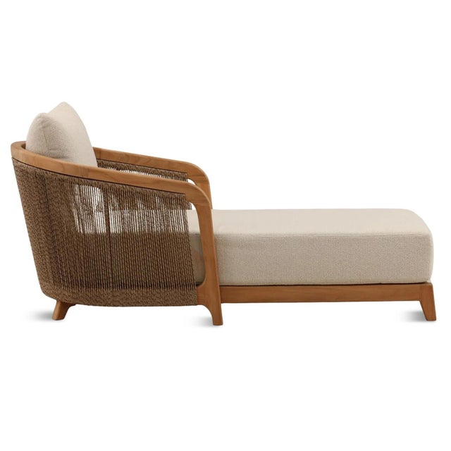 Outdoor teak wood frame accent chair with brown poly rope wrap. Cozy sand colored upholstered cushions. Each may vary in...