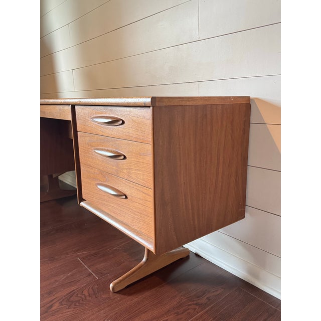 A mid century modern teak vanity dressing table, circa 1960s. Made by the renowned British furniture maker, Austinsuite,...