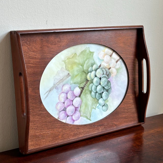 Offering a gorgeous Limoges-style, hand painted porcelain plaque set in a handsome two-handle wooden tray. Love the oval...