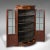 This is an antique glazed corner cabinet. An English, mahogany and glass bow front display cupboard, dating to the...
