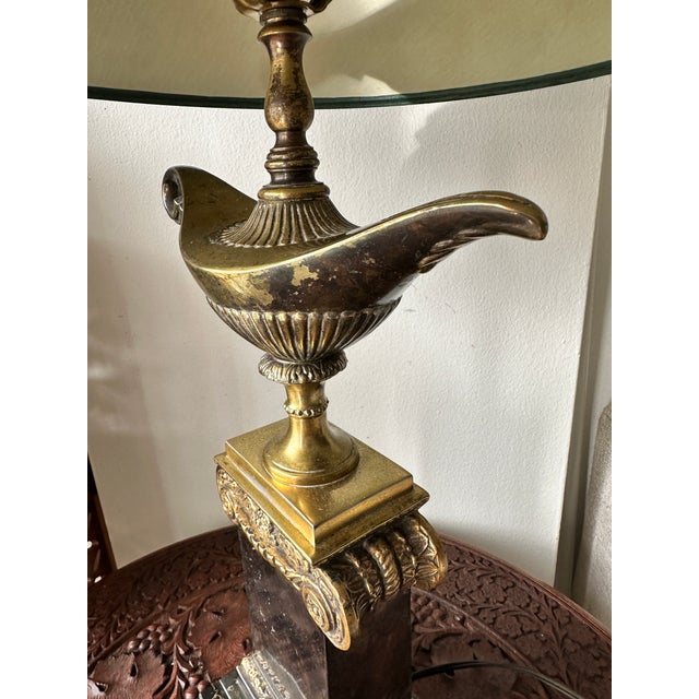 Elegant Frederick Cooper "Aladdin" table lamp featuring the iconic genie lamp motif mounted atop a classical column...