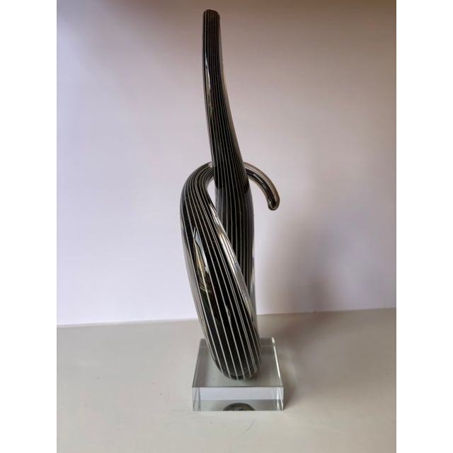 Standing 10 inches high by 4 1/2 wide and by 2 1/2 deep this Love Knot hand blown glass Murano sculpture from Venice made...