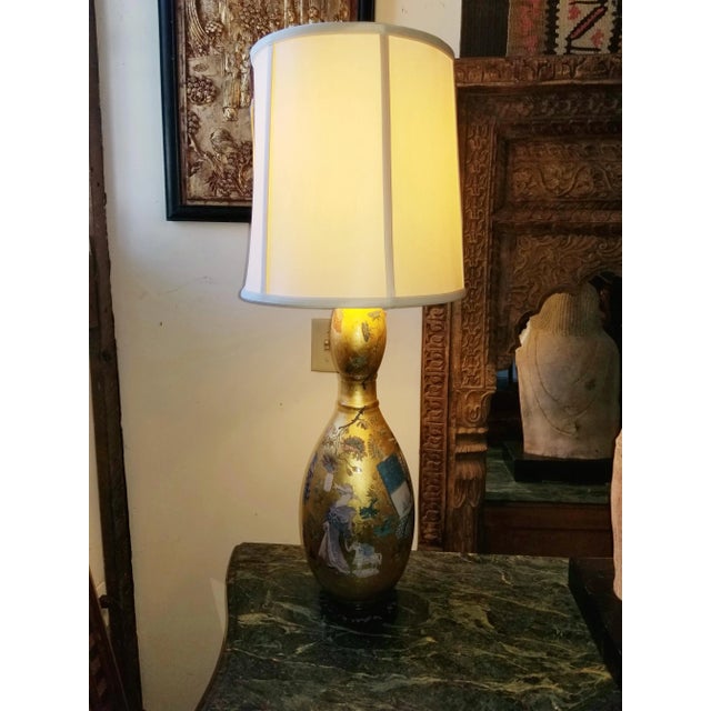 This richly detailed lamp will add glistening warmth wherever you place it. The scenes depicted are charming and a...