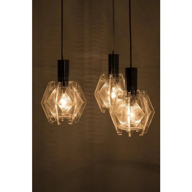 Wonderful Sompex hanging lamp with 3 separate lamps designed by Paul Secon. The lamp is made from acrylic glass and nylon...