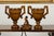 A pair of English vintage carved walnut lidded urns from the mid 20th century, with large handles and fluted motifs....