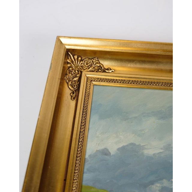 Oil painting framed in a gilded wooden frame with the motif of a cabin out in a mountain landscape. Signed by P. Svarter...