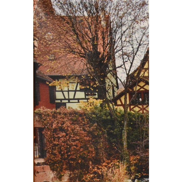 Bring the charm of the French countryside into your home with 'Alsatian Charm,' a beautifully captured scene printed on...