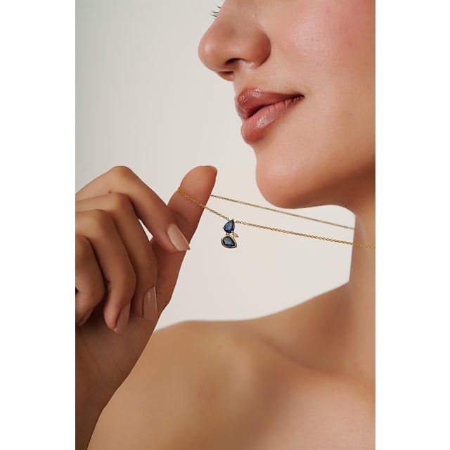 This pendant necklace features 1.66 carats of deep blue sapphires set in 14K yellow gold. The sapphire measuring 4.8 x 7.2...