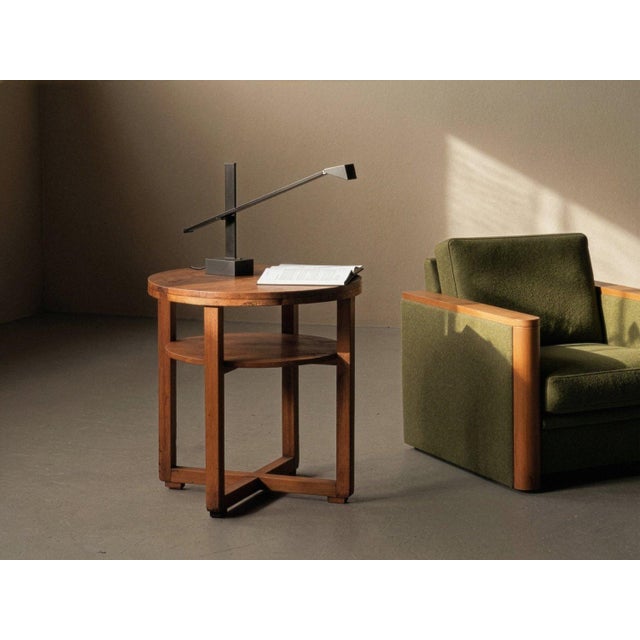 Side table, crafted in France around 1950, features a thick circular top resting on four straight uprights, connected by a...