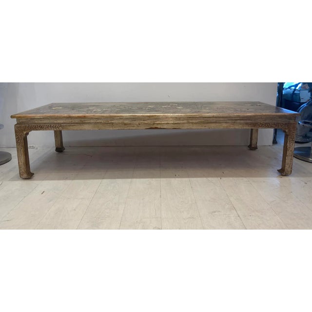 Ming style coffee table in a lacquered finish with carved floral decoration and silver leaf tone. Signed by Max Kuehne a...