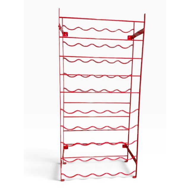 Striking vintage 1980s Herby wine rack in glossy red painted steel, featuring an instantly recognizable sculptural...