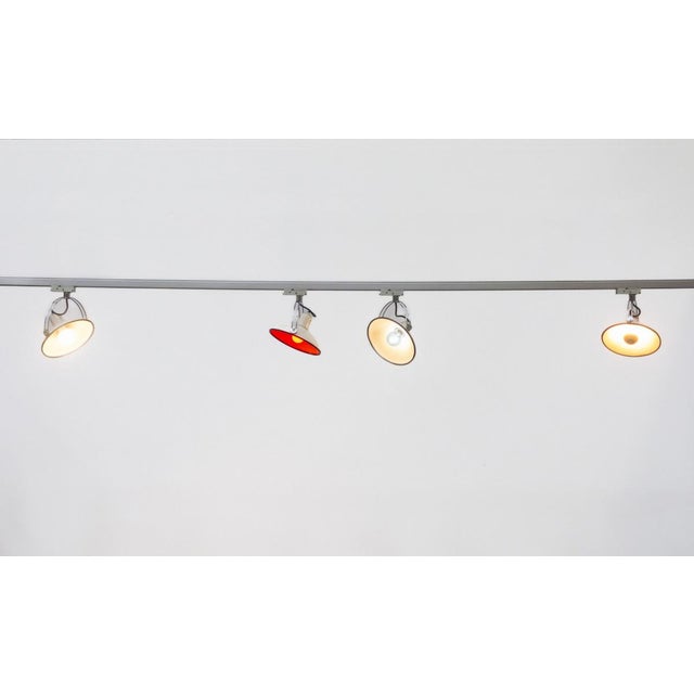 Set of four industrial moon lamps, produced by philips in the 1980s and mounted on a finnish nokia xts electrified track....
