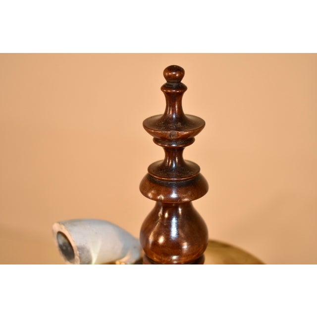 Circa 1800 American walnut tavern pipe stand. The central piece of the stand is elegantly hand turned and has a hand made...