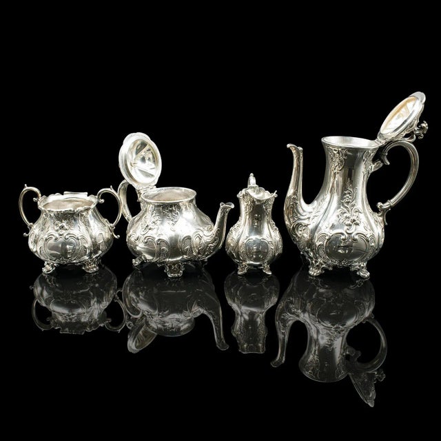 This is a fine antique four piece tea service, beautifully crafted in silver plate over cast white metal, dating to the...