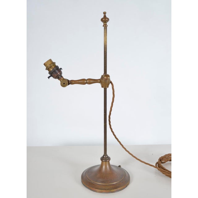 Original Arts and Crafts brass student desk lamp by Faraday and Son, circa 1900, raised on a nicely weighted circular base...