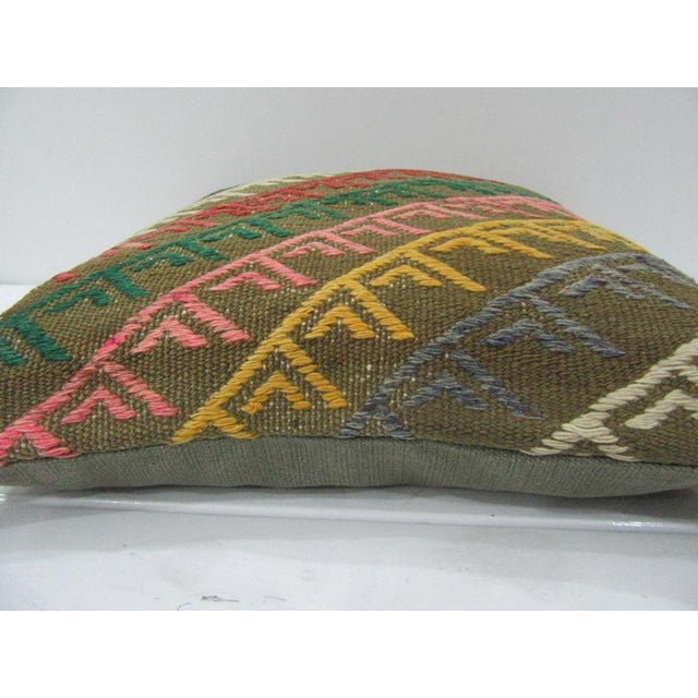 This is a pillow cover made from a vintage kilim rug. The piece was properly washed and ready to use. Pillow inserts not...