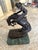 A beautiful high quality replica of “The Rattlesnake” by Frederic Remington set on a green marble base.