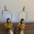 Pair of small brass engraved boudoir lamps with urn style bodies. The engravings on the lamps look to be done by hand and...