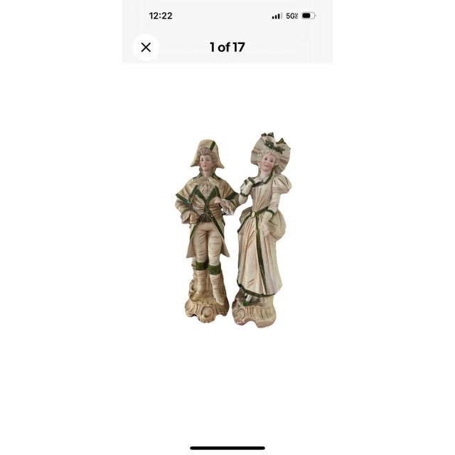 Graceful pair of porcelain figurines depicting an aristocratic man and woman dressed in intricate 18th-century Regency-...