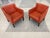 These Børge Mogensen-style lounge chairs were made in Denmark in the 1960s. They have red-orange leather upholstery and...