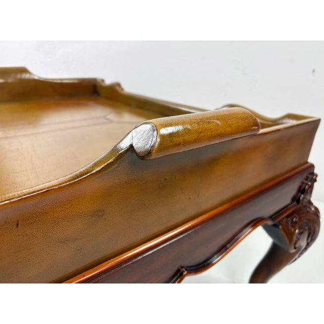 This is an English Chippendale style mahogany and leather galley tray coffee table. This coffee table has beautifully...