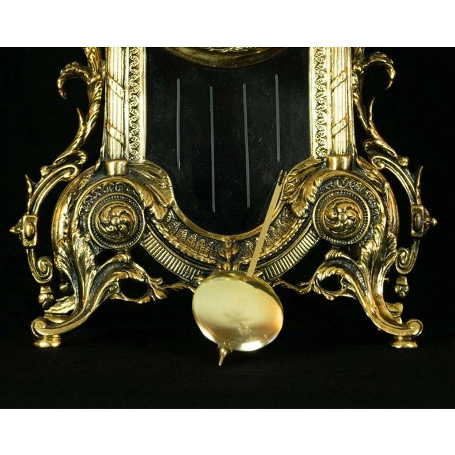 An impressive vintage brass mantel clock by Robert Grant of London, combining traditional European clock design with a...