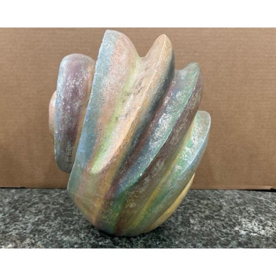 An eye-catching decorative wooden sculpture carved in the form of a nautilus shell, featuring a dramatic spiral volute...