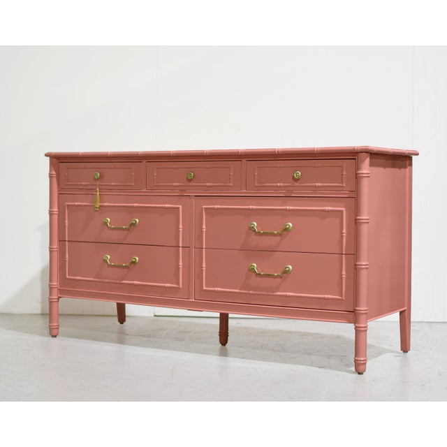 We have a beautiful Mid Century Hollywood Regency Faux Bamboo Dresser with Brass Hardware by Thomasville, newly painted in...