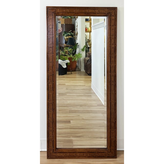 Large vintage carved wood mirror in mid century modern style. Rich natural wood tones to frame that feature geometric...