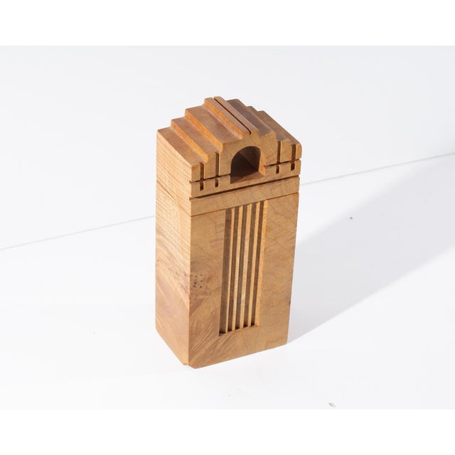 A handcrafted box made from burl maple wood by American woodworker Michael Elkan of Maple Leaf Studio. This piece...