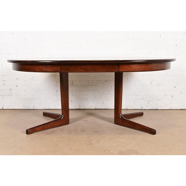 A sleek and stylish mid-century Danish Modern sculpted rosewood extension dining table By Skovby Møbelfabrik Denmark,...