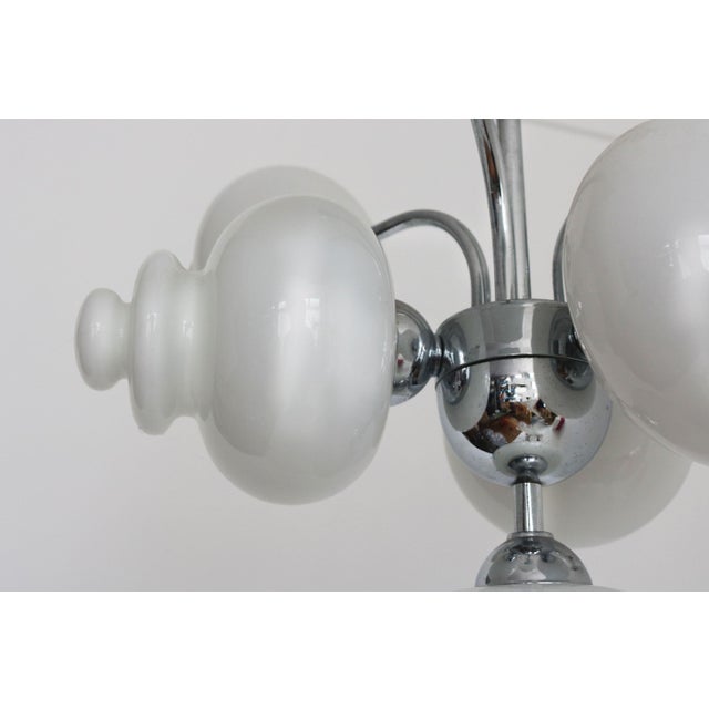 A stunning vintage 7-light chandelier by Boulanger, showcasing the bold, futuristic elegance of 1970s Space Age design....
