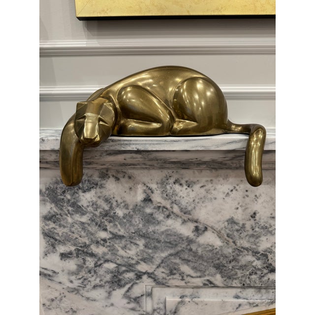 Impressive large-scale Dolbi Cashier brass reclining panther sculpture, measuring 16 inches in length and retaining its...