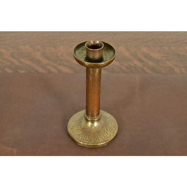 A gorgeous Arts & Crafts period brass finished hand hammered copper candlestick By Roycroft (signed with impressed orb and...