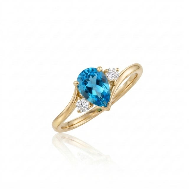 Bring a splash of vibrant, ocean-blue brilliance to your jewelry collection with this stunning pear-cut bypass ring. At...
