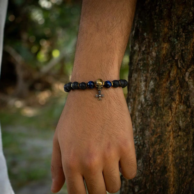 The Skull Charm Fleur de Lis Symbol Black Beaded Bracelet is a stylish and unique piece of handmade jewelry that combines...