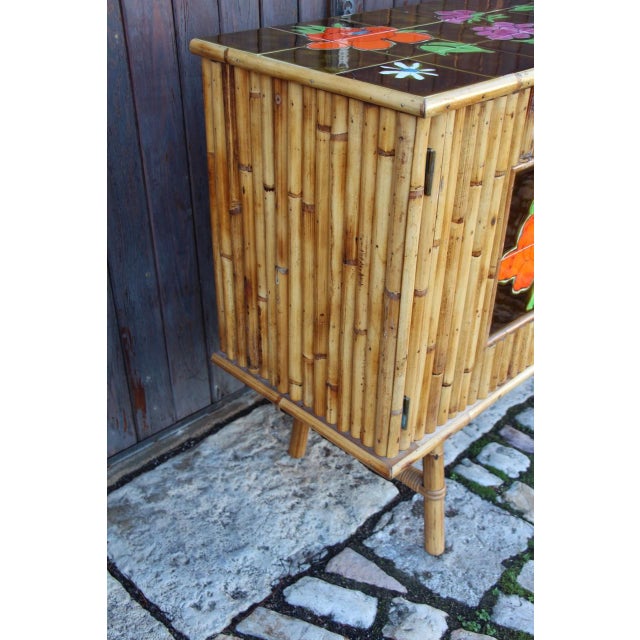 1960s sideboard in bamboo and ceramic tiles. Overall, in good condition. Only two tiny cracks to note on the edge of the...