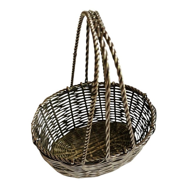 Small silver basket with 3 different styles of roped handles. Hand made probably in Mexico. Excellent condition....