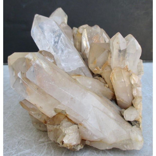 Clear to milky quartz cluster. Large natural points on top and druzzy surface clusters formed on the lower surface. The...