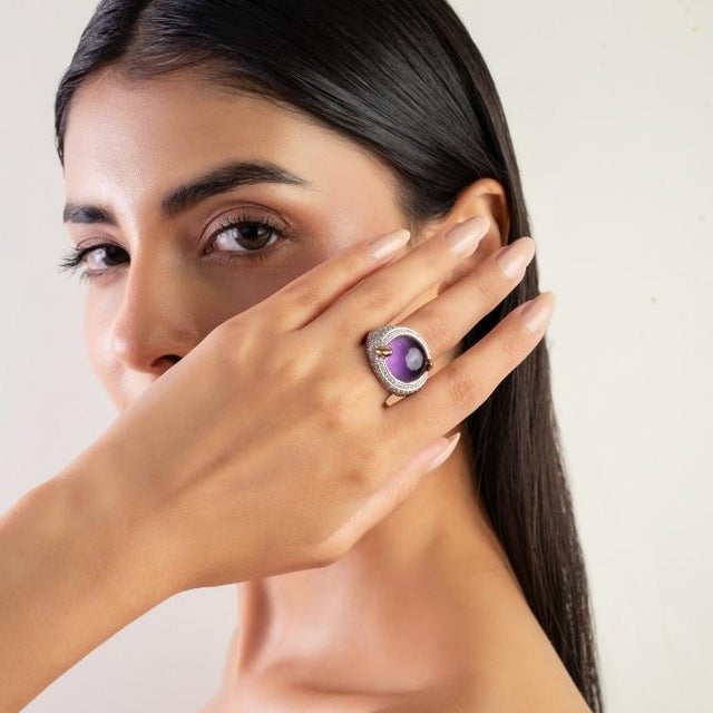This vintage-style dome ring features 1 cabochon cut amethyst totaling 14.21 carats, set in rich 18K yellow gold. The...
