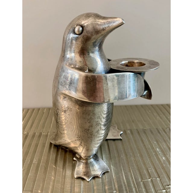 Vintage Restoration Hardware, silver plated penguin candle holder for one candle. The penguin holds his top hat which...