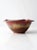This is a vintage studio pottery bowl. Signed by the artist, the handmade bowl features a wave crested top rim with...